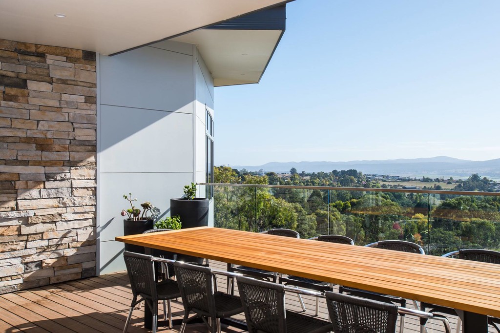 Home outdoor deck and dining area with a view 