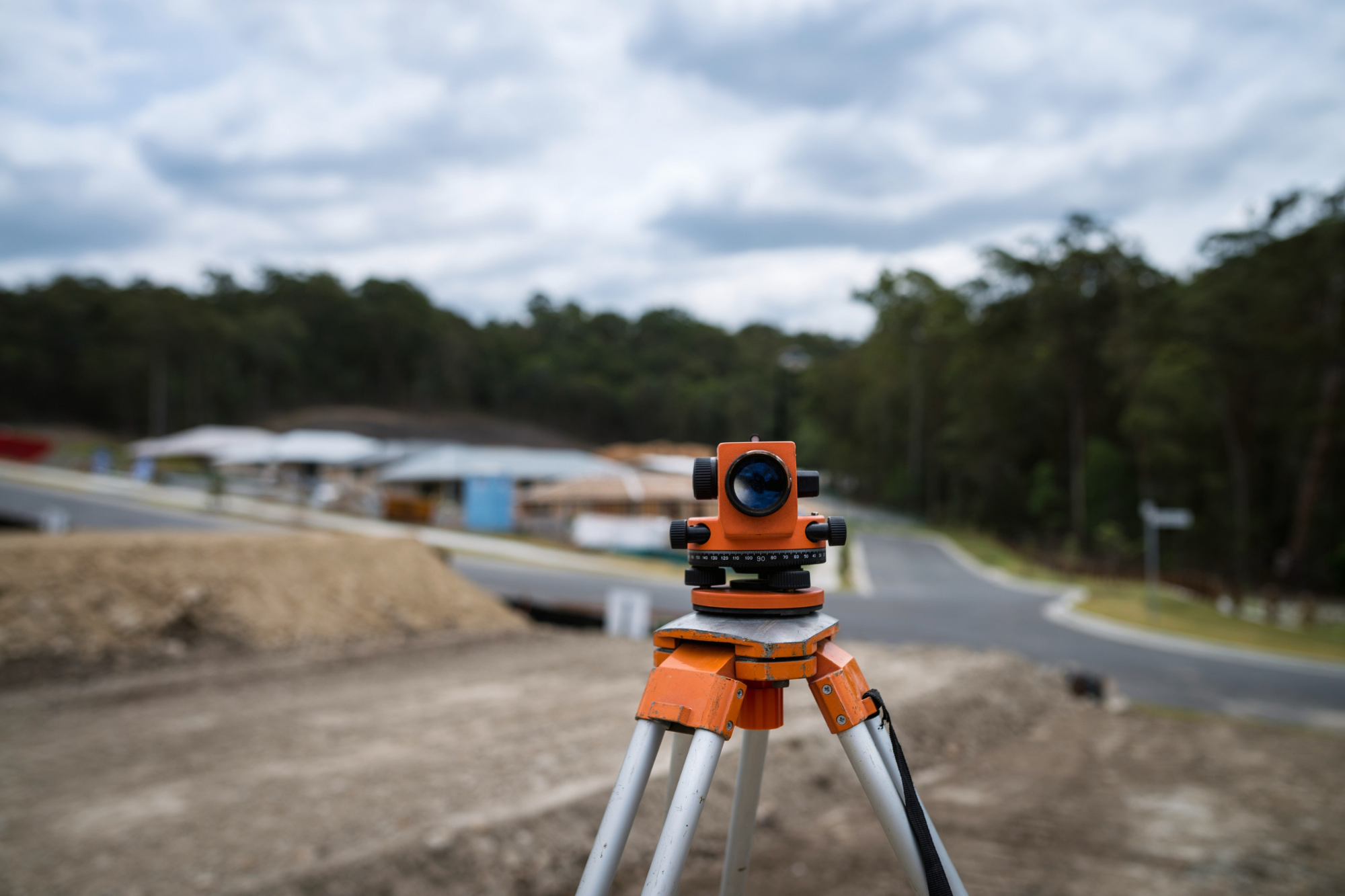 Land surveying equipment set up at a new subdivision where new homes are being built.